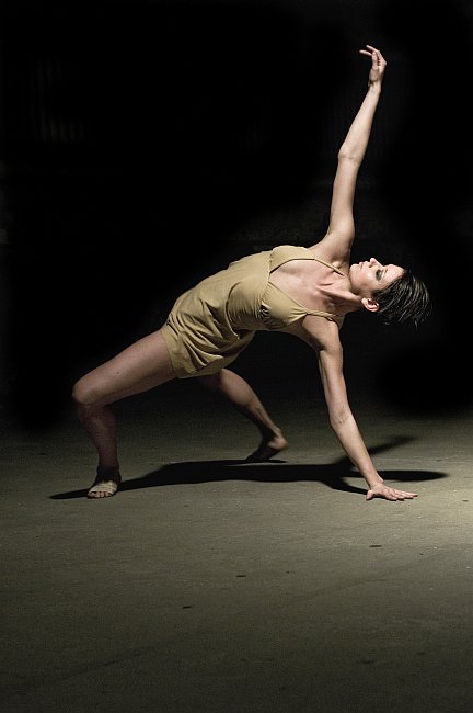 fotografia: tancerka na scenie, opiera się o podłogę nogami i jedną ręką