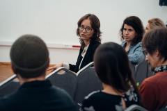 fotografia - kilka osób siedzących na krzesłach